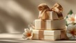 © Natalia S. - A stack of luxury gold gift boxes tied with satin ribbons and small white flowers under soft light. The image emphasizes elegance, celebration, and premium retail presentation