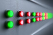 © Nakarin - Programmable LED control panel glowing softly in red and green lights on textured surface