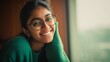 © Khawla - Smiling Indian Woman in Green Sweater by Window
