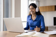 © fizkes - Cheerful student girl in wireless headphones watching learning webinar