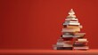 © Johannes - stack of books forming a christmas tree shape against a vibrant red background symbolizing holiday creativity and festive education