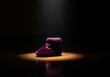 © Meow Creations - Single burgundy velvet baby bootie dramatically illuminated in a dark, low key setting