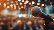 © CinimaticWorks - public speaker man in front of audience with microphone giving seminar lecture, congress symposium event, business presentation, knowledge sharing and corporate communication