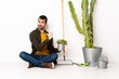 © luismolinero - Gardener man sitting on the floor at indoors proud and self-satisfied