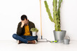 © luismolinero - Gardener man sitting on the floor at indoors with tired and sick expression