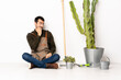 © luismolinero - Gardener man sitting on the floor at indoors is a little bit nervous
