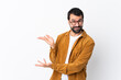 © luismolinero - Caucasian handsome man with beard wearing a corduroy jacket over isolated white background extending hands to the side for inviting to come