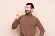 © luismolinero - Man over isolated background intending to realizes the solution while lifting a finger up