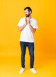 © luismolinero - Full-length shot of man with beard over isolated yellow background scheming something