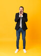 © luismolinero - Full-length shot of business man over isolated yellow background shouting and announcing something
