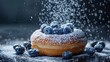 © Ummeya - A close up of a donut topped with blueberries and powdered sugar being sprinkled on top of it