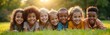 © miss irine - Diverse group of happy children lying on green grass in garden. Smiling at camera with bright eyes, joyful expressions, bathed in warm sunlight. Children from different ethnicities enjoy time