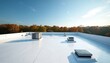 © miss irine - Modern white flat commercial roof features various HVAC systems, ventilation units, skylights. Reflective membrane provides energy efficiency for building construction. Clear blue sky, vibrant autumn