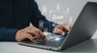 © Razaul Karim - Persons hands typing on a laptop with a digital audit checklist interface displayed on screen