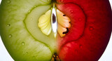 Juicy half-cut apple with vibrant red and green hues, glistening with fresh water droplets, a perfect healthy snack for a refreshing summer day