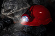 © TSViPhoto - Protective miner's helmet, hard hat with a flashlight in a mine underground in a tunnel in the dark. Concept of miner occupation. Professional protective headgear