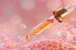 © Tohamina - Golden liquid drips from a glass dropper onto a magnified cellular structure with floating spheres illustrating advanced cosmetic treatment