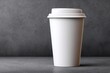 © trustmastertx - Minimalist White Coffee Cup on Gray Background for Mockup.