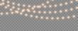 © dlyastokiv - Christmas lights with glowing bulbs. Bright garland decoration for holiday. Gold Christmas and New Year bright garlands on transparent background, led light strips - for stock