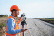 © Serhii - Surveyor using theodolite and walkie talkie at construction site