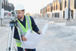 © Serhii - Surveyor working at new construction site with blueprint
