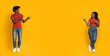 © Prostock-studio - Two young adults in matching red shirts stand on a bright yellow background, playfully pointing at each other. They are smiling, creating a lively and energetic atmosphere together.