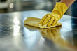 © Stockistock - Woman cleaning table with rag in room. hand in rubber glove holds rag, house cleaning concept