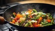 © Rostyslav - Fresh mixed vegetables stir-frying in a sizzling black wok pan