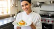 © Panen - Chef Presenting Exquisite Dish in Professional Kitchen Setting.