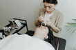 © Nataliya - Portrait of a girl cosmetologist extending eyelashes to a woman.