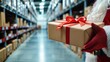© HikikomorAI - Santa Claus Holding Holiday Gift Box in Modern Distribution Warehouse for Christmas Online Retail and Fast Delivery Logistics