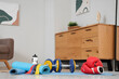 © Pixel-Shot - Sports equipment on floor in living room