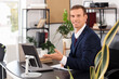 © Pixel-Shot - Handsome businessman working at desk in office