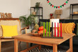 © Pixel-Shot - Candles with fruits for Kwanzaa celebration on table in living room