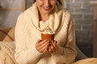 © Pixel-Shot - Beautiful young happy woman with cup of hot chocolate and whipped cream sitting in evening at home, closeup