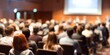 © hao - Conference Audience Blur: A blurred background of an audience at a conference or seminar, with rows of seats and people listening attentively. High quality