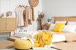 © Pixel-Shot - Rack with stylish clothes in interior of bedroom