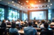© Audrey - Blurred image of education people and business people sitting in conference room for profession seminar and the speaker is presenting new technology and idea sharing with the content activity.