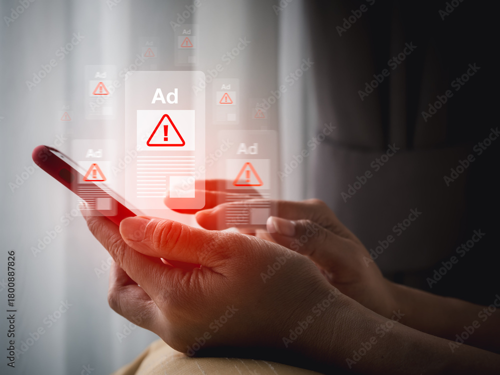 Hand holding smartphone with scam ad warning popups symbolizes online ...