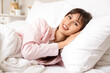 © Pixel-Shot - Morning of beautiful young woman lying on pillow in bedroom