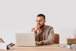 © Pixel-Shot - Thoughtful businessman using laptop to search online in office
