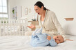 © Pixel-Shot - Screaming mother with her baby suffering from postnatal depression in bedroom