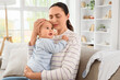 © Pixel-Shot - Young mother with her baby suffering from postnatal depression on sofa at home