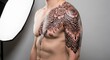 © photoplotnikov - Young caucasian male with detailed floral tattoo sleeve on chest and shoulder