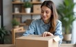 © li - Starting Small business entrepreneur SME freelance, Portrait young woman working at home office, BOX, smartphone, laptop, online, marketing, packaging, delivery, b2b, SME, e-commerce concep