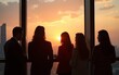 © Luke - A group of diverse business people engages in brainstorming on a high rise balcony at sunset, fostering creativity and collaboration. The silhouette adds an inspiring and contemplative ambiance.