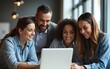 © Samuel - A diverse group of business people gather around a laptop in a modern office. High quality
