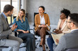 © NDABCREATIVITY - Portrait of successful business people working, talking together in corporate office during work.