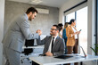 © NDABCREATIVITY - Happy office staff, success employee giving hand for shaking. Business people offering handshake