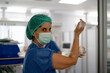 © Carmen - Female surgeon scrubbing hands preparing for operation